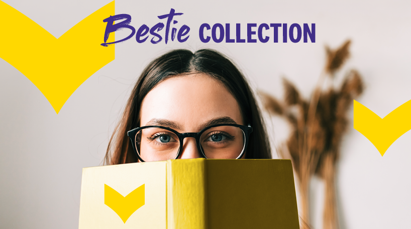 A woman wearing glasses peeks over the top of an open book