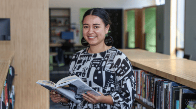 Girl holding a book at the library